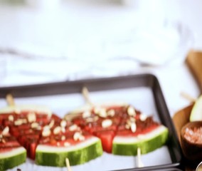 Wall Mural - Watermelon drizzled with chocolate and topped with flaked sea salt, almonds and coconuts