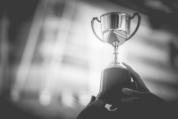 black and white trophy with city background. success and achievement concept. sport game and award t