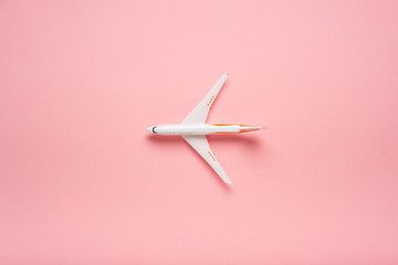 Wall Mural - Top view of an airplane on trendy pink background.  Bright summer color. Travel concept.