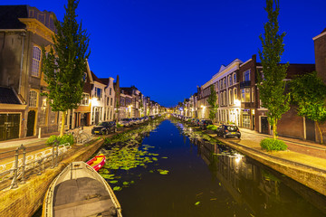 Wall Mural - Street view on canals and monumental houses in historical city Gouda, the Netherlands