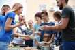 © New Africa - Volunteers serving food for poor people outdoors