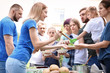 © New Africa - Volunteers serving food for poor people outdoors