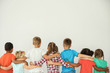 © New Africa - Little children hugging each other with hands on light background. Unity concept