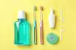 Flat lay composition with manual toothbrushes and oral hygiene products on color background
