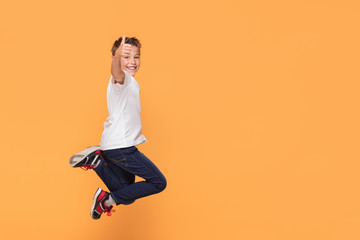 little boy jumping in the studio, smiling.