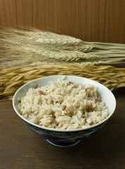 Canvas Print - A Cooked  Jasmine Rice , Brown Rice in bowl  on wood table.