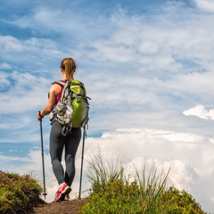 Wall Mural - young woman hiking in the mountains