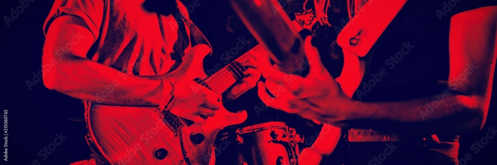 Man and woman playing guitars in nightclub - obrazy, fototapety, plakaty 