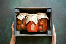 Autumn Preserves Of Tomatoes And Vegetable Puree In Glass Jars Placed In Wooden Box. Homemade Autumn Canning Products
