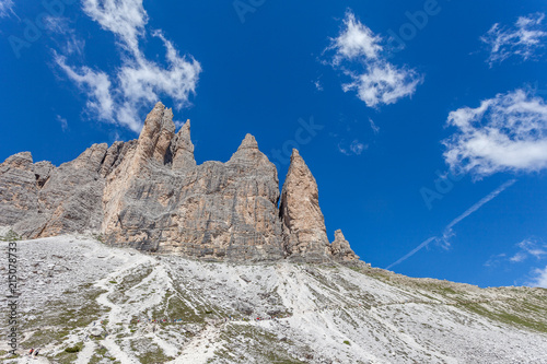 Fotografie, Obraz Column of tourists walking at the foot of the Tre Cime di Lavaredo, Dolomites, I