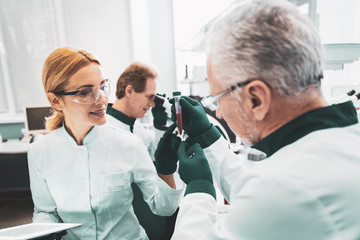 Chemical assistant. Promising chemical assistant feeling exited while cooperating with her demanding scientific advisor