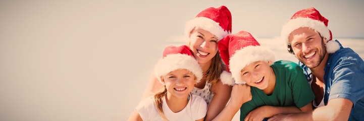 Wall Mural - Portrait of happy family wearing Santa hat at beach