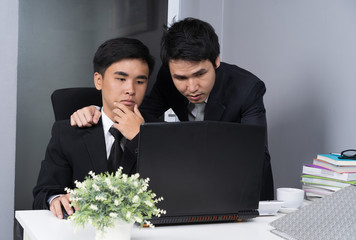 two business man using laptop and discussing project