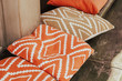 Orange cafe pillows on the desk closeup. Cafe exterior and interior. Restaurant furniture decoration