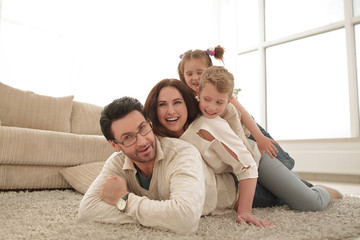 Wall Mural - Happy family at home spending time togethe