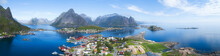 Beautiful aerial panorama of  the blue sea surrounding the fishing village  and rocky peaks Reine, Moskenes, Lofoten, Norway, sunny arctic summer 