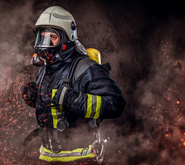 Wall Mural - A firefighter dressed in a uniform in a studio.