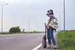  girl with a guitar hitch-hiking