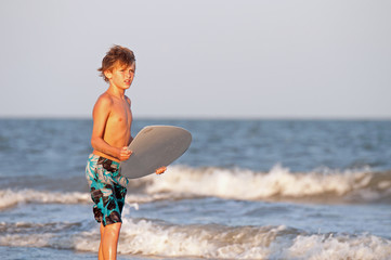 A boy waiting to catch the perfect wave