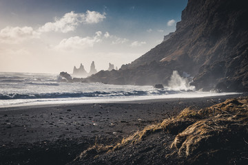Wall Mural - sunrise at famous black sand beach reynisfjara in iceland. windy morning. ocean waves. colorful sky.