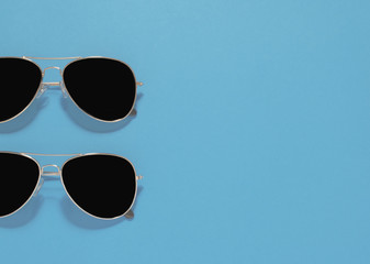 2 sunglasses on a blue background