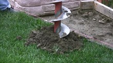 Two Man Auger Digging Fence Post Holes In The Ground