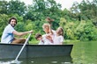 © LIGHTFIELD STUDIOS - happy young family riding boat on lake at park together