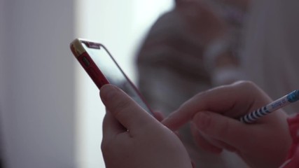 Poster - Smartphone in children's hands. Stock. Smart phone in the hands of a child