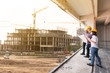 © stnazkul - three construction engineers working together in construction site planning for the renovation