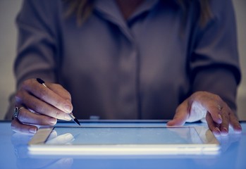 Hands holding using digital tablet on a cyber space table