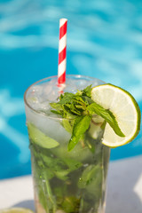 Wall Mural - mojito cocktail on a pool background