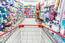 Supermarket Aisle And Shelves In Blurry For Background