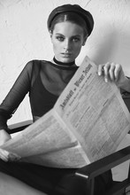 Black And White Portrait Of Beautiful Woman In Newsboy Cap With Vintage Newspaper In Hands. Retro Style