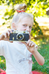 little pretty girl with retro camera