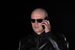 © serikbaib - portrait of a bald man with a phone