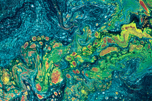 Marbling textured creative background. Mixing green, blue, yellow and red pai...