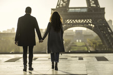 Couple Holding Hands Near Eiffel Tower