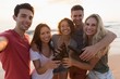 © Wavebreak Media - Group of friends standing together in the beach