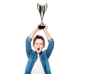 Wall Mural - schoolboy screaming and holding winner cup above head isolated on white