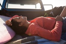 Woman Sleeping In A Pickup Truck At Beach