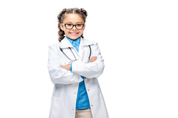 Wall Mural - happy schoolchild in white coat standing with crossed arms isolated on white