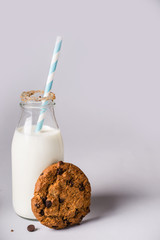 Wall Mural - chocolate chip cookies and bottle of milk is decorated with cookies crumbs