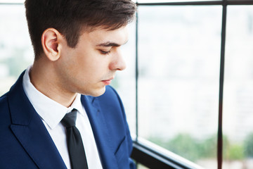 Wall Mural - Portrait of a frustrated and worried young handsome businessman.