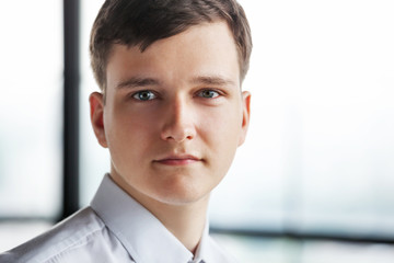 Wall Mural - Portrait of young business man looking at camera.