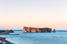 Famous Large Rocher Perce Rock In Gaspe Peninsula, Quebec, Gaspesie Region, Canada At Sunset, Saint Lawrence Gulf, Boat, Ship, Houses, Wharf, Dock, Pier