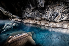 Wide Angle View Of Inside Of Grjotagja Lava Cave Near Lake Myvatn With Hot Springs Blue, Green Water, Rocks, Rocky Formations, Walls, Reflection