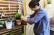 © Luca Pierro/Stocksy - Woman gardening in a patio
