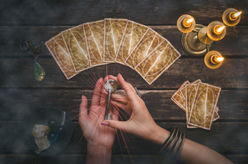 Wall Mural - Tarot cards on fortune teller desk table background. Magic key to secrets of fate. Futune reading concept. Divination.