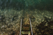 © Lyuba Burakova/Stocksy - Ladder to the sea overgrown with algae