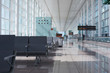 © Miquel Llonch/Stocksy - Modern airport hall with empty seats